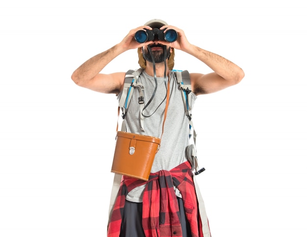 Backpacker with binoculars over isolated white background