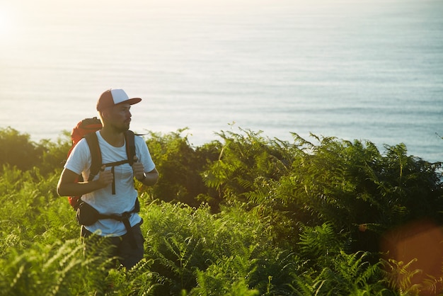 Backpaker hiking on hills near sea