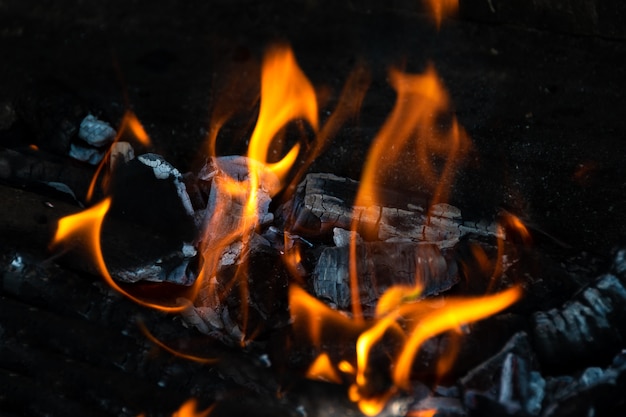 Backyard outdoor fireplace full of burning embers