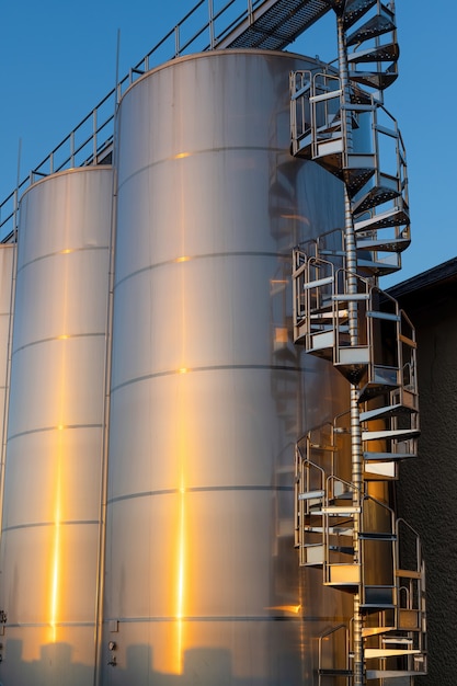 Backyard of winery at sunset with metal wine storage tanks