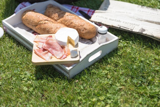 Bacon with cheese and bread over green grass