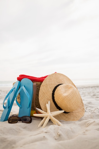 Bag and beach accessories kept on sand