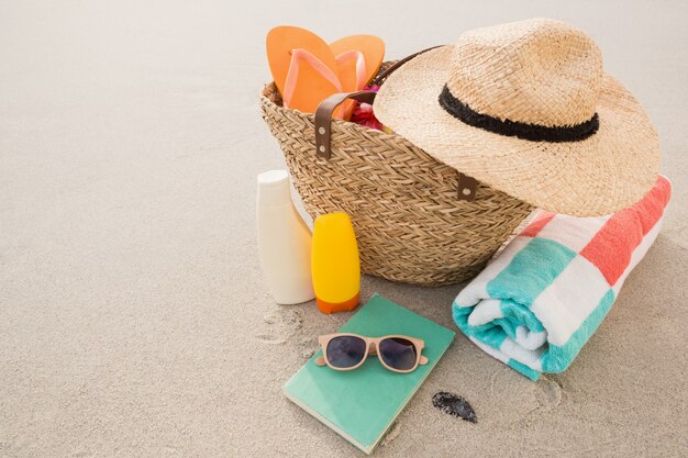 Bag with beach accessories on sand