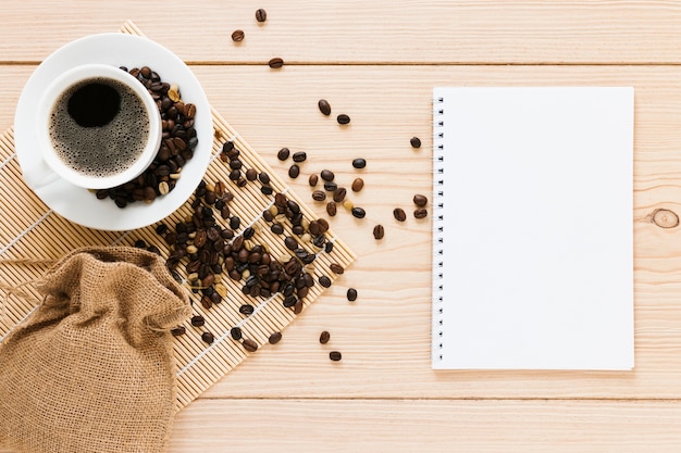 Free Photo bag with coffee beans and notebook mock-up