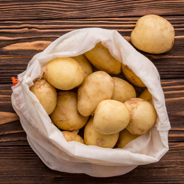 Bag with potatoes on floor