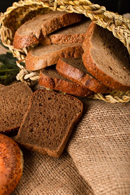 Bagel and slices of dark bread in basket