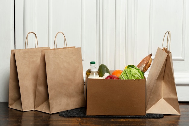 Bags and vegetable box on mat