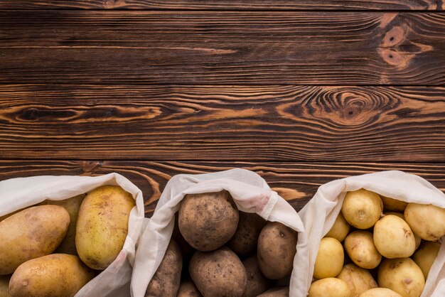 Bags with potatoes on floor