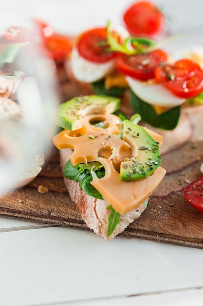 baguette and cheese on wooden board