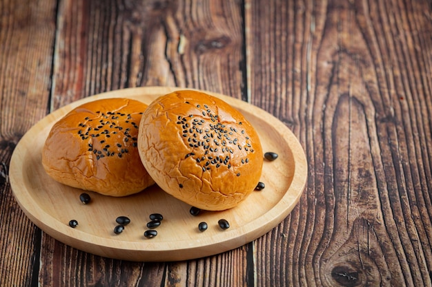 baked black bean paste buns put on dark floor