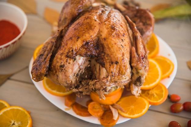 Baked chicken with oranges on light table