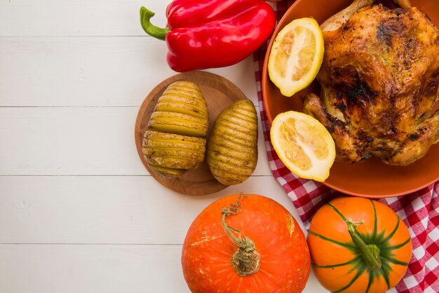 Baked chicken with potatoes on table