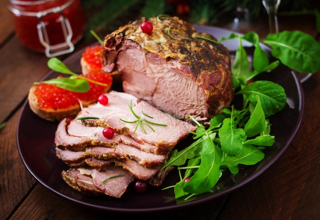 baked ham and red caviar, served on old wooden table.