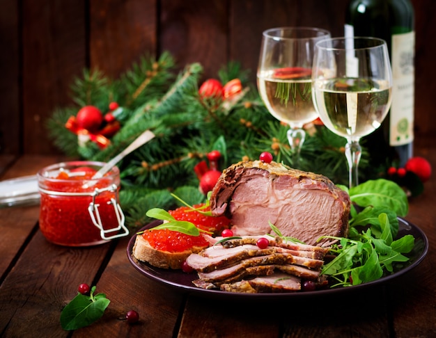 baked ham and red caviar, served on old wooden table.