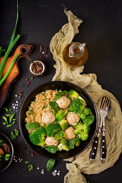 Baked meatballs of chicken fillet with garnish with quinoa and boiled broccoli. Proper nutrition. Sports nutrition. Dietary menu. Flat lay. Top view