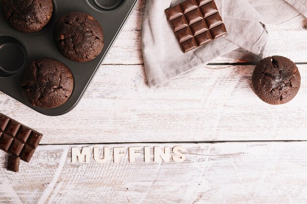 Baked muffins with text on white table