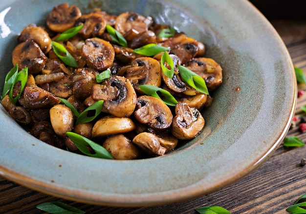 Baked mushrooms with soy sauce and herbs. Vegan food.