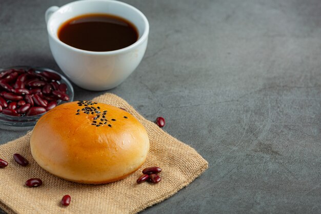 baked red bean paste buns place on brown fabric served with coffee