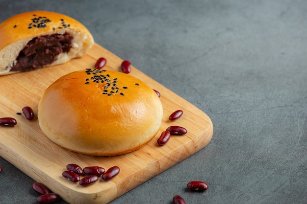 baked red bean paste buns on wooden cutting board