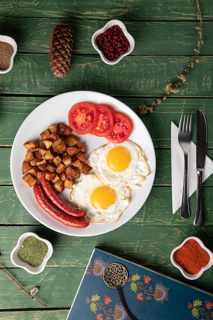 Baked sausage with eggs and potato