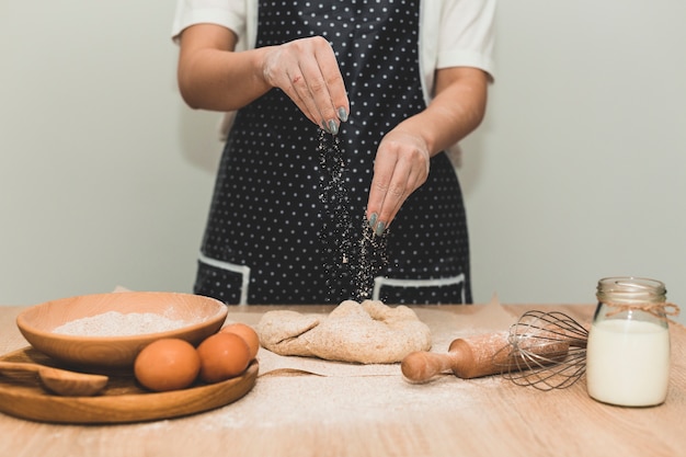 Free photo baker making dough for bread