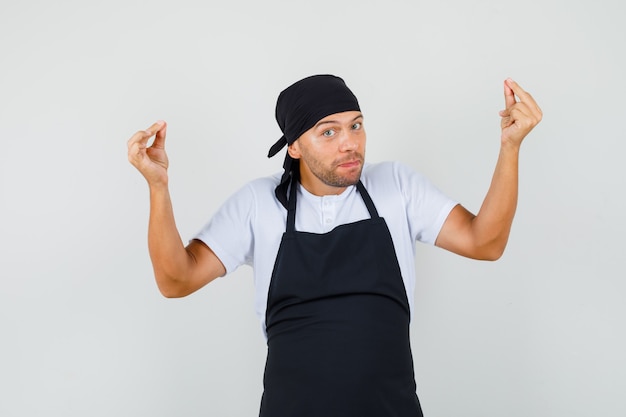 Free photo baker man doing meditation gesture in t-shirt