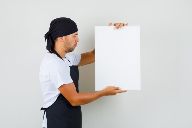 Baker man holding empty canvas in t-shirt