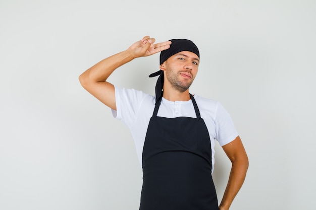 Free photo baker man pointing hand and fingers to head in t-shirt