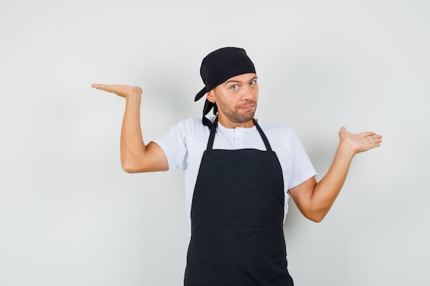 Free photo baker man in t-shirt, apron making scales gesture