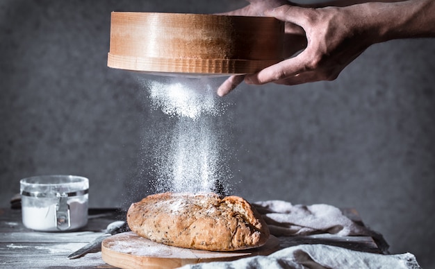 baker with flour in his hand