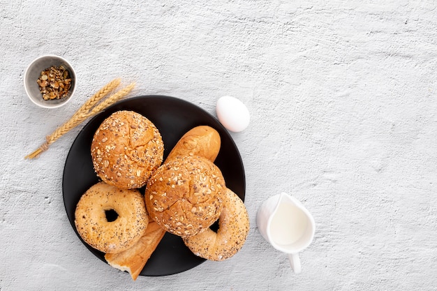 Free photo bakery doughnuts and baguette on plate with copy space