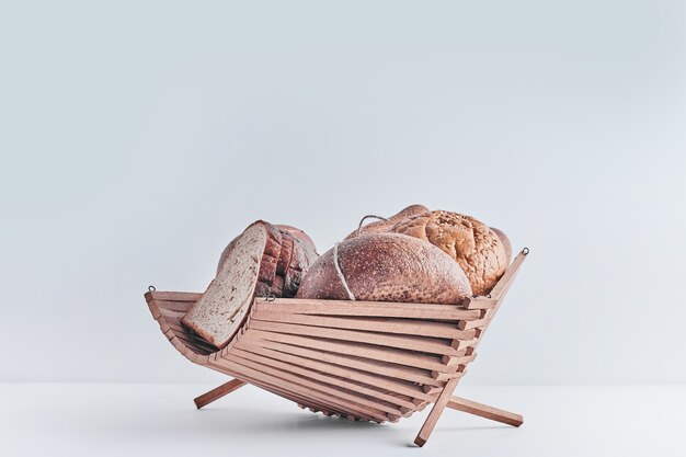 Bakery products on white table in a wooden basket.