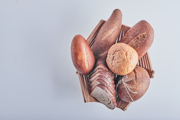 Bakery products on white table in a wooden basket.