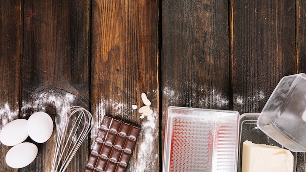 Free Photo baking a cake ingredients with kitchen utensil on wooden plank