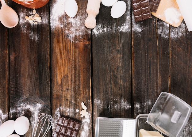 Baking a cake ingredients with kitchen utensil on wooden table top