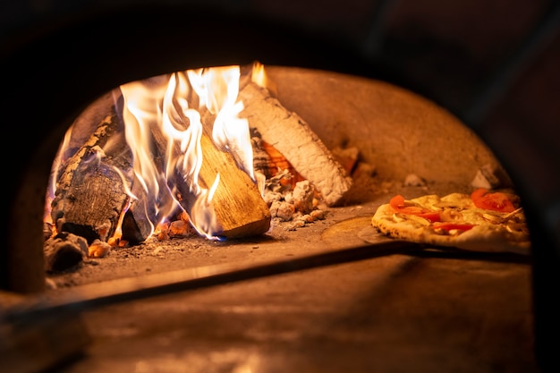 Baking delicious pizza with wood fired oven