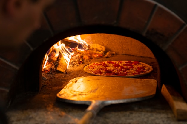 Free photo baking delicious pizza with wood fired oven