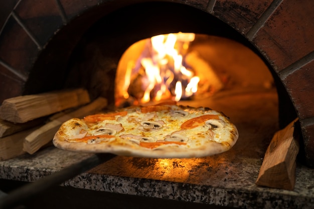 Free photo baking pizza in wood fired oven