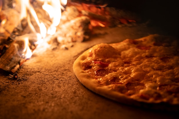 Free photo baking pizza in wood fired oven