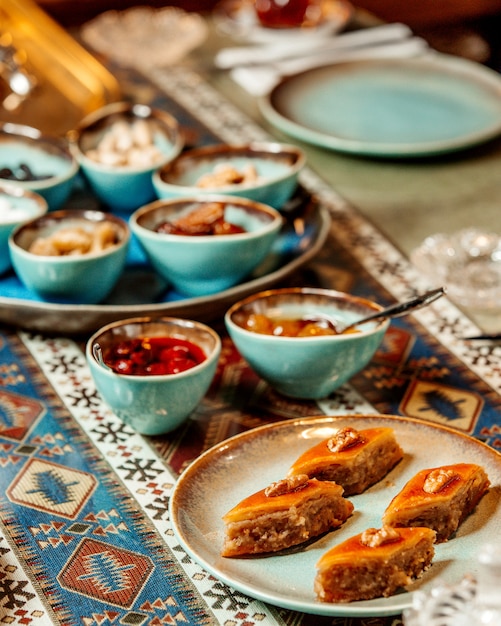 Baklava some jams and dried fruits on the table