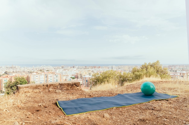 Ball and towel for yoga with the city at the background