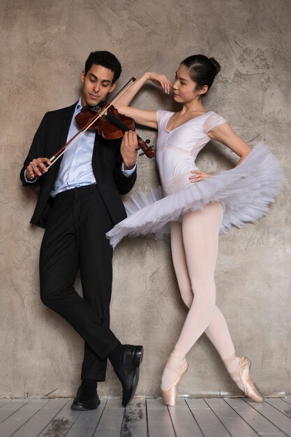 Ballerina listening to musician playing violin