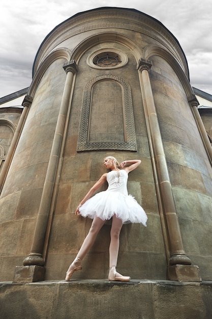 Ballerina performing near an old castle