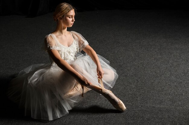 Ballerina in tutu dress posing with copy space