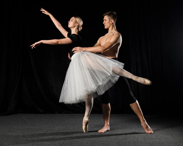 Ballet couple posing in tutu and tights