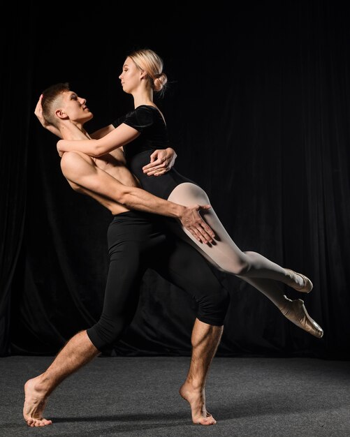 Ballet couple posing while embraced