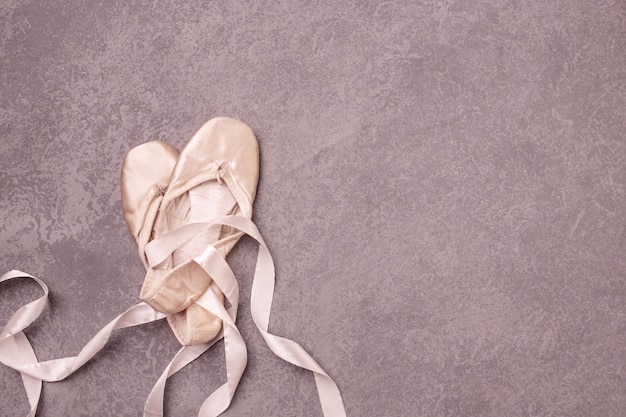 Ballet pointe shoes on pink