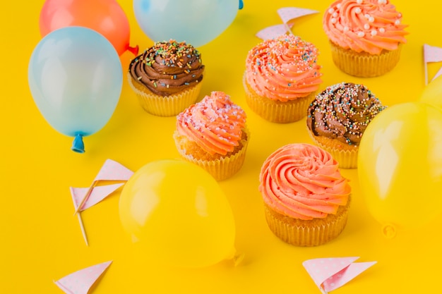 Balloons and cupcakes with sprinkles