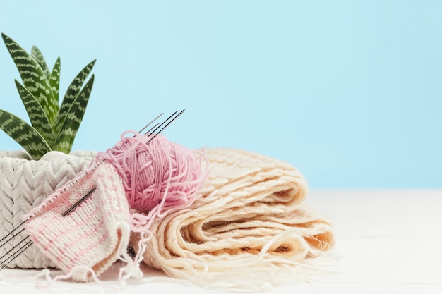 balls of wool on white wooden background