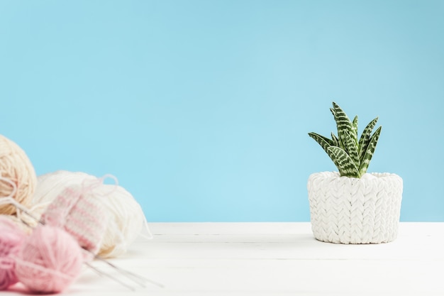 balls of wool on white wooden background